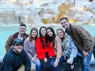 SAI study abroad students posing in front of the pool