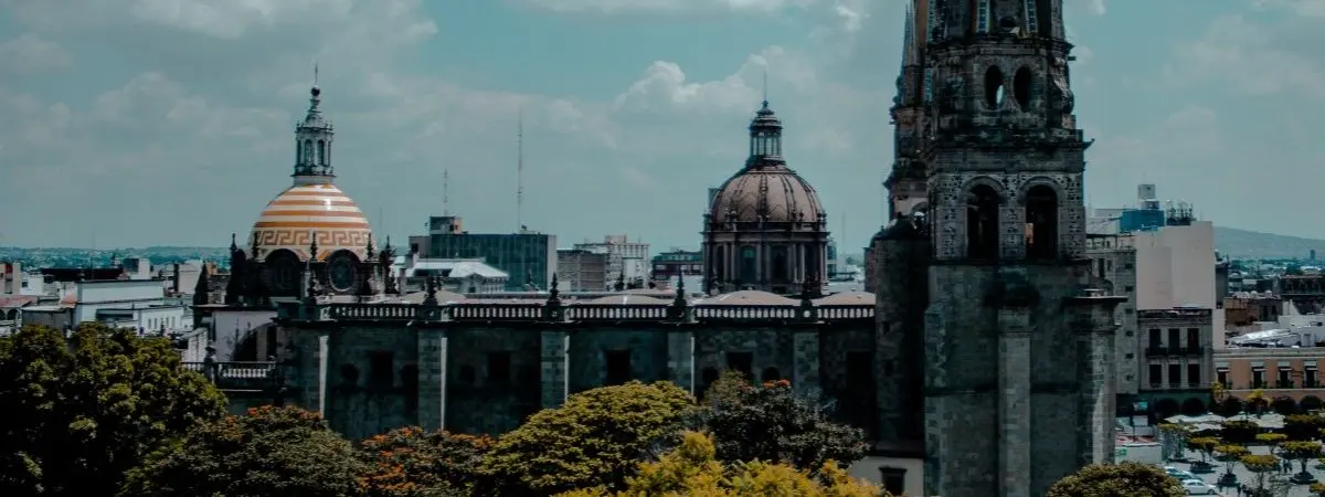 tall buildings under blue sky with clouds