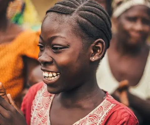 Crowded group of African Americans in Sierra Leone where the focus is on one young woman