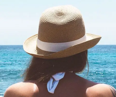 woman in hat at the beach