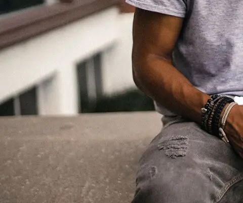 Teen boy writing in notebook