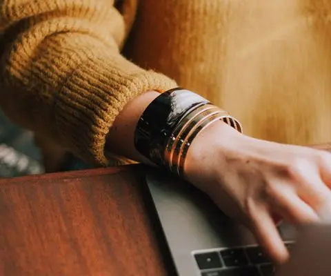 teacher typing on their laptop