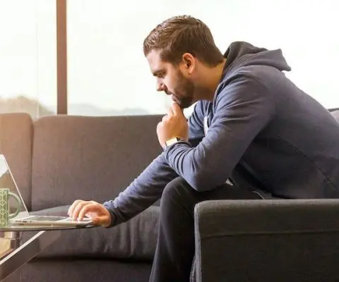person using laptop on the couch