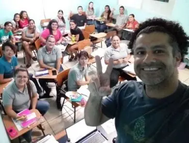 a photo of an ITA teacher with his students