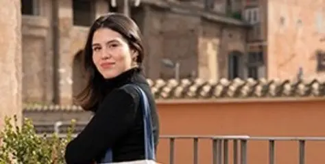 John Cabot University student holding a tote bag