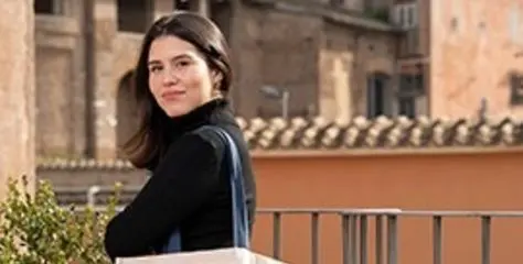 John Cabot University student holding a tote bag