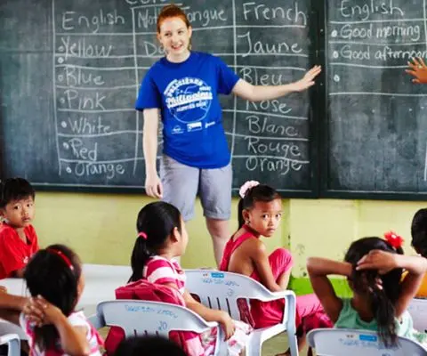 A volunteer teaching English to children