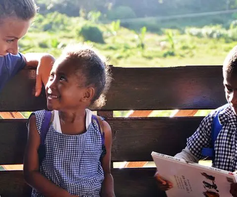 A volunteer reading stories to local kids