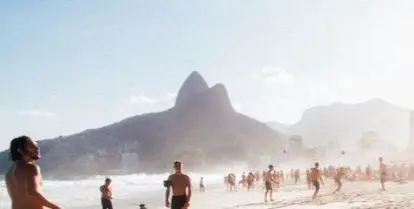 people playing volleyball on sandy beach