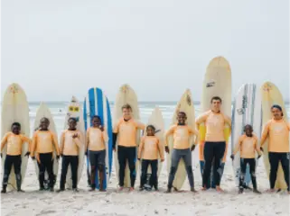 volunteers teaching children to surf in South Africa