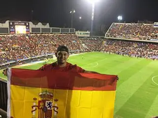 Student holding the big flag of Spain.