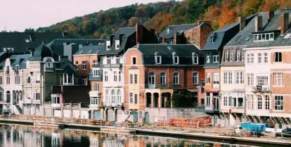 buildings in different colors sitting next to water