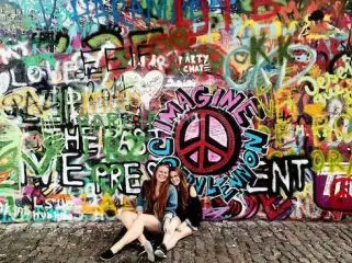 two girls and a graffitied wall